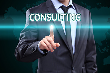 Image showing Businessman pressing button on touch screen interface and select Consulting. Business,  technology concept.