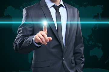 Image showing business, technology, internet and networking concept - businessman pressing button with contact on virtual screens. World map