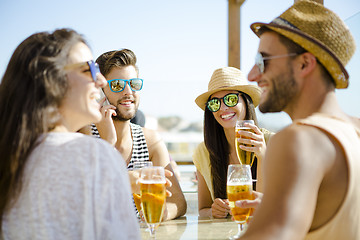 Image showing Friends at the beach bar