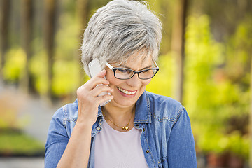 Image showing Mature woman talking at phone