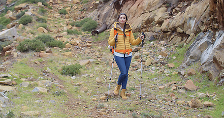 Image showing Fit healthy young woman hiking on a trail