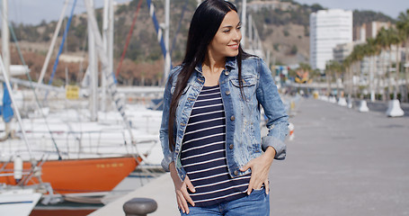 Image showing Casual woman enjoying a walk through a marina