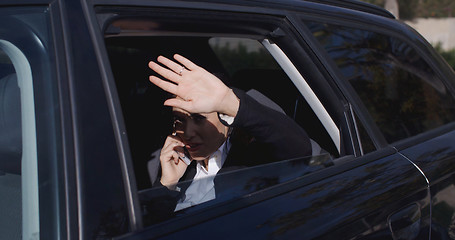 Image showing Executive in car blocking view from window