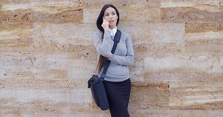 Image showing Woman using phone and waiting on hold