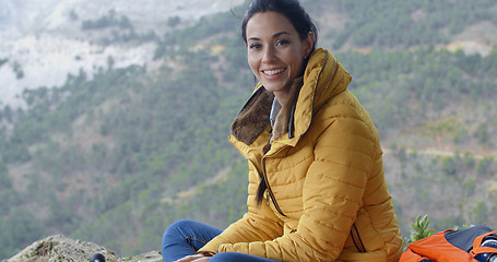 Image showing Smiling young woman hiking in the mountains