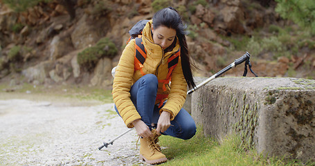 Image showing Female hiker tying her laces