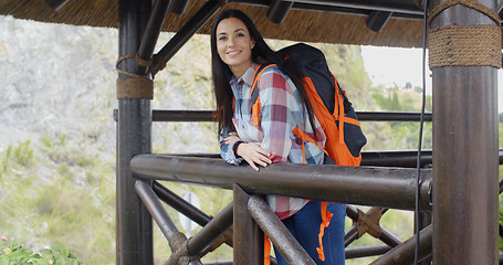 Image showing Smiling backpacker on a mountain lookout