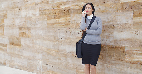 Image showing Woman using phone and waiting on hold