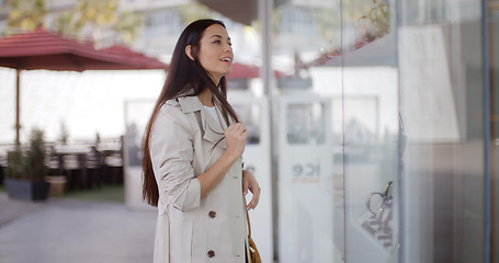 Image showing Young woman shopping in an urban mall