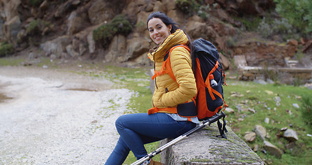 Image showing Smiling young woman on a mountain trail