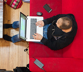 Image showing High angle view of a man using his laptop