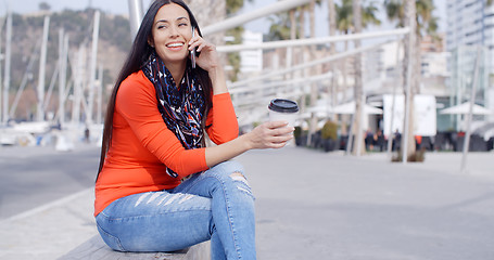 Image showing Relaxed confident young woman on a mobile