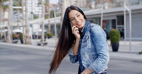 Image showing Happy casual young woman swinging her hair