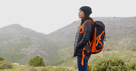 Image showing Happy smiling woman enjoying a misty hike