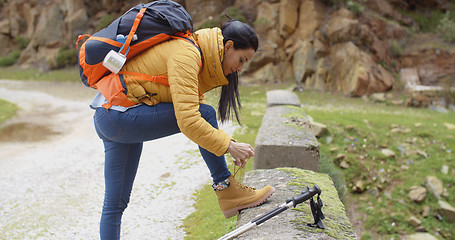 Image showing Female hiker tying her laces