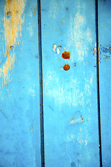 Image showing dirty   paint in the blue wood  and rusty nail