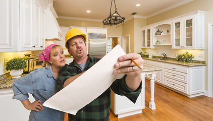 Image showing Contractor Discussing Plans with Woman Inside Custom Kitchen Int