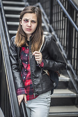 Image showing Young Bruised and Frightened Girl With Backpack on Staircase