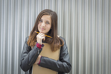 Image showing Young Melancholy Female Student With Books Looking to the Side