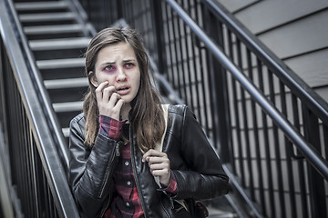 Image showing Young Bruised and Frightened Girl With Backpack on Staircase