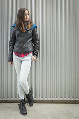 Image showing Young Teen Girl Standing Against Metal Wall