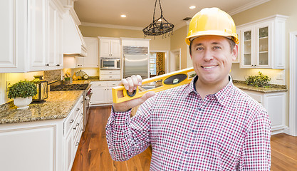 Image showing Contractor with Level Wearing Hard Hat Standing In Custom Kitche