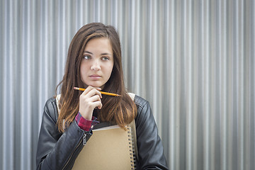 Image showing Young Melancholy Female Student With Books Looking to the Side