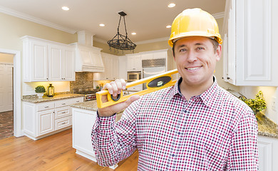 Image showing Contractor with Level Wearing Hard Hat Standing In Custom Kitche