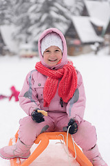 Image showing little girl sitting on sledges