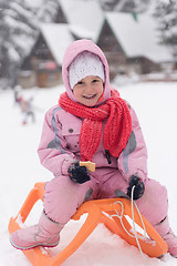 Image showing little girl sitting on sledges