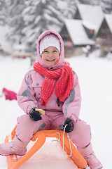 Image showing little girl sitting on sledges