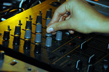 Image showing DJ and his mixing desk