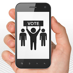 Image showing Political concept: Hand Holding Smartphone with Election Campaign on display