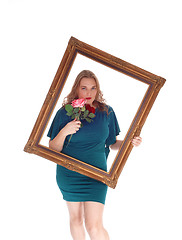 Image showing Woman looking trough picture frame