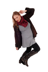 Image showing Lovely woman in winter coat dancing.