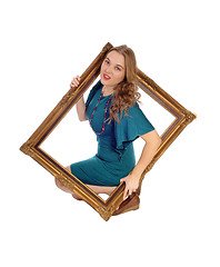 Image showing Woman looking trough picture frame.
