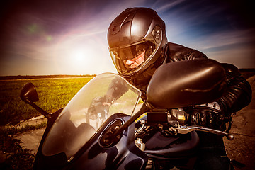 Image showing Biker racing on the road