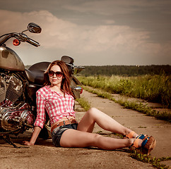 Image showing Biker girl sitting on motorcycle