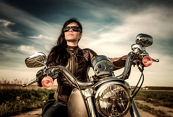 Image showing Biker girl sitting on motorcycle