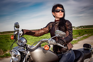 Image showing Biker girl sitting on motorcycle