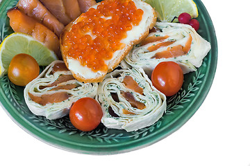 Image showing Baked fish and vegetables on plate on white background.