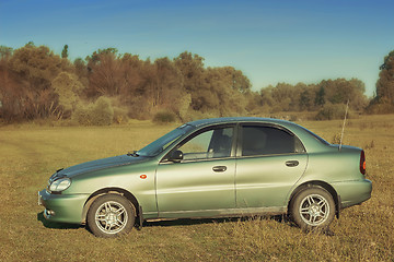 Image showing The car on the green lawn.