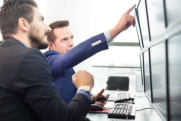 Image showing Stock traders looking at computer screens.