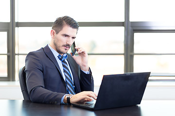 Image showing Businessman in office working on laptop computer.