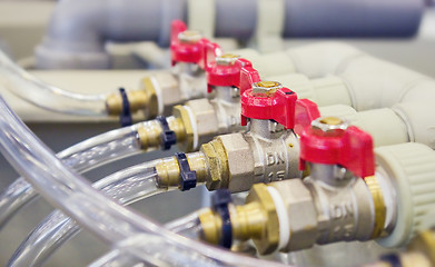 Image showing Compact brass distributor with red valves