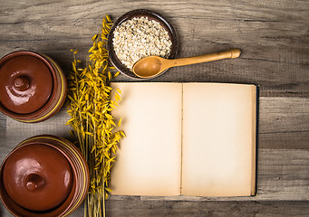 Image showing The top view on the opened cookbook and kitchen utensils