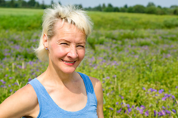 Image showing Portrait of a woman amid the summer meadows in the countryside  