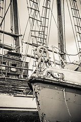 Image showing Old collapsing sailboats at the dock, close-up, sepia