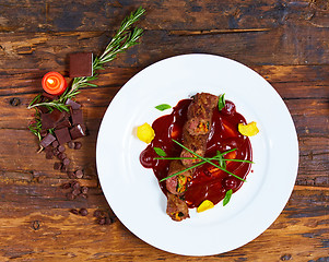 Image showing Roasted meat with vegetables and chocolate sauce