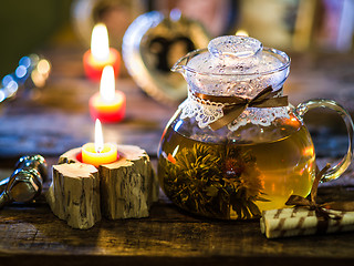 Image showing exotic green tea with flowers in glass teapot 